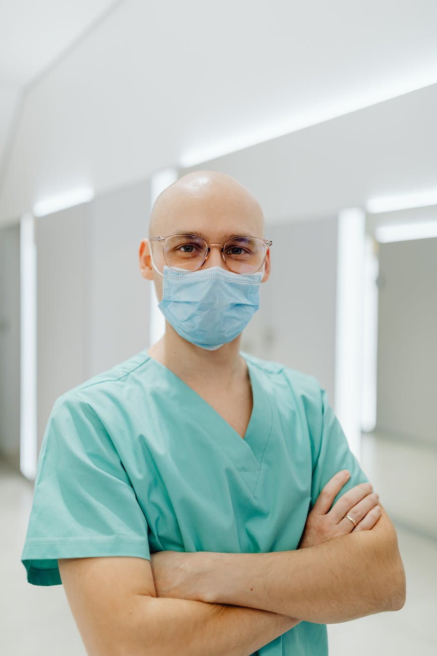 health worker in a teal scrub suit