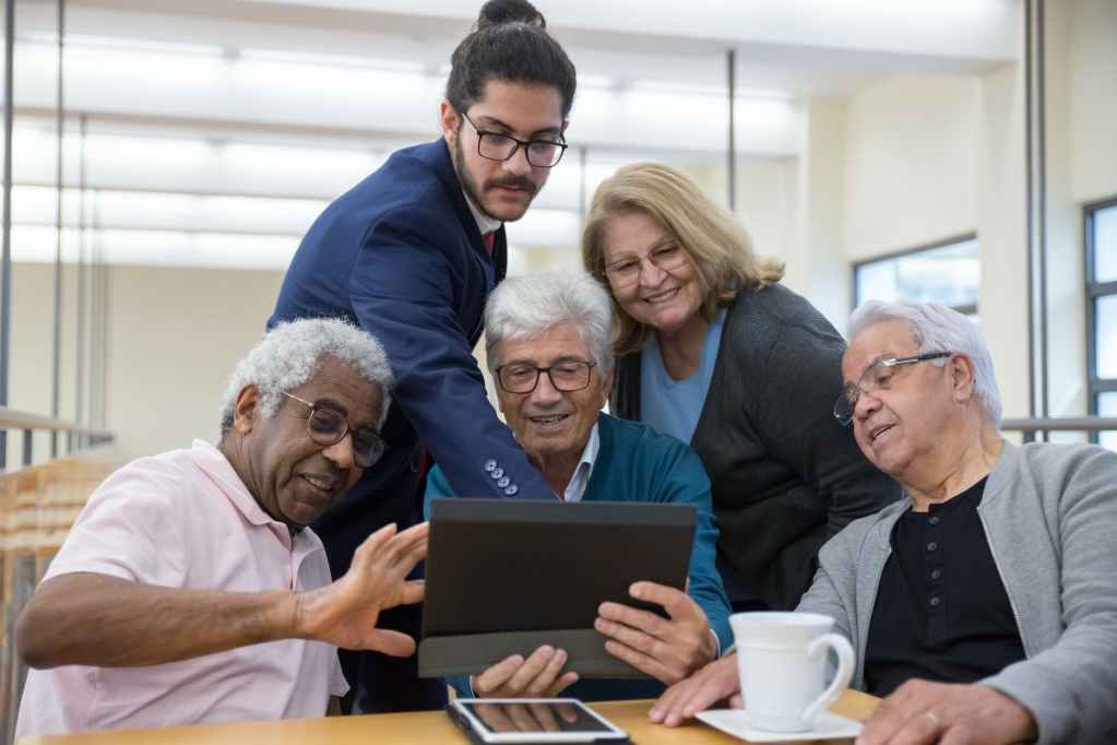 man in black polo shirt holding black tablet computer